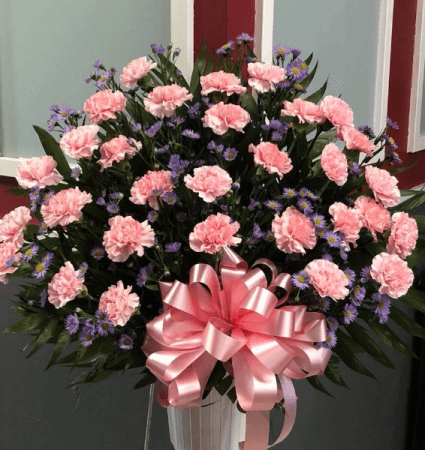 Pink carnations in a funeral basket