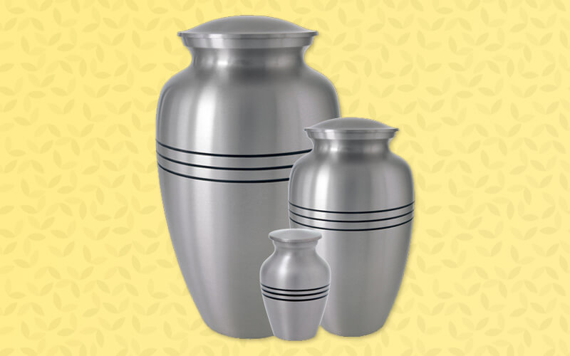 three traditional shaped metal urns